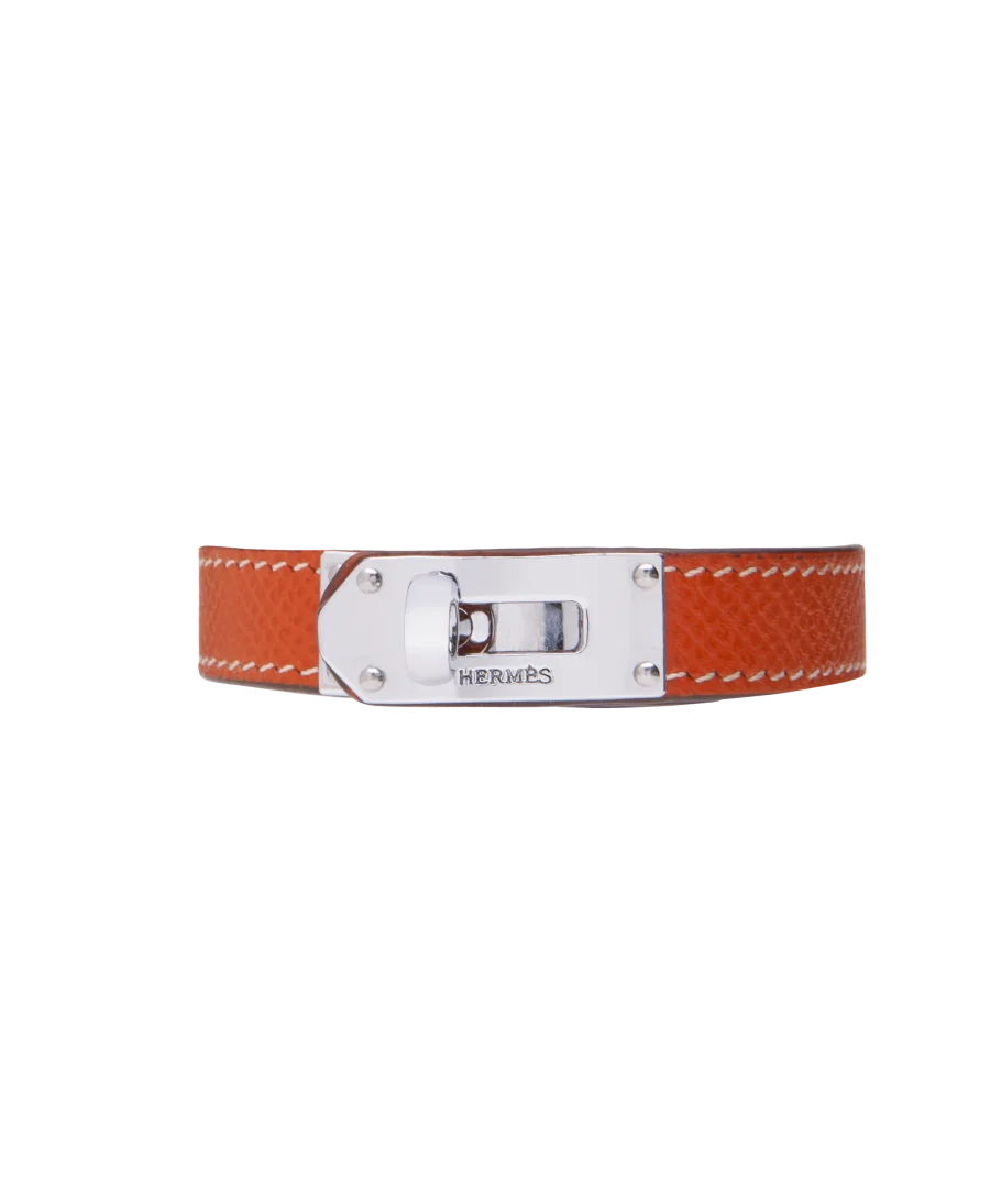 Armband des Luxuslabels Hermès aus Stahl und orangefarbenem Leder. Erhältlich bei VIRTU LUXURY. Armband des Luxuslabels Hermès aus Stahl und orangefarbenem Leder. Erhältlich bei VIRTU LUXURY.